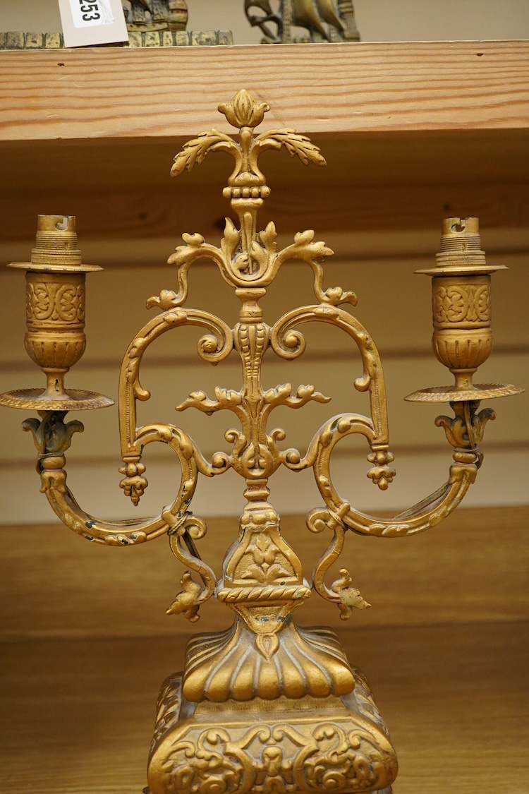 A pair of brass candlesticks and a gilt metal two branch gilt candelabrum, 45cm high